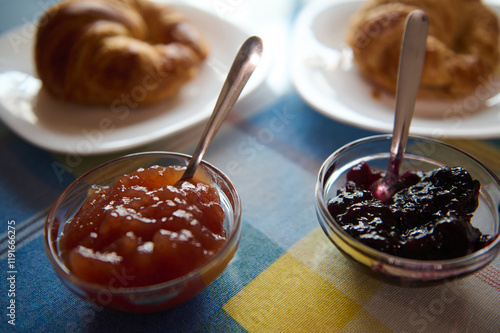 Breakfast Table with Croissants and Jelly on a Checkered Cloth photo