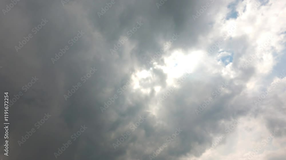 A time-lapse cloudscape natural background in summer cloudy day. Dark clouds building in at air. Sunlight beams through dramatic rain clouds in atmosphere A time-lapse cloudscape natural background in summer cloudy day. Dark clouds building in at air. Sunlight beams through dramatic rain clouds in atmosphere