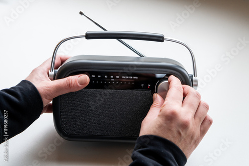Fotografie CLose up of  female hands tuning old fashion style radio set