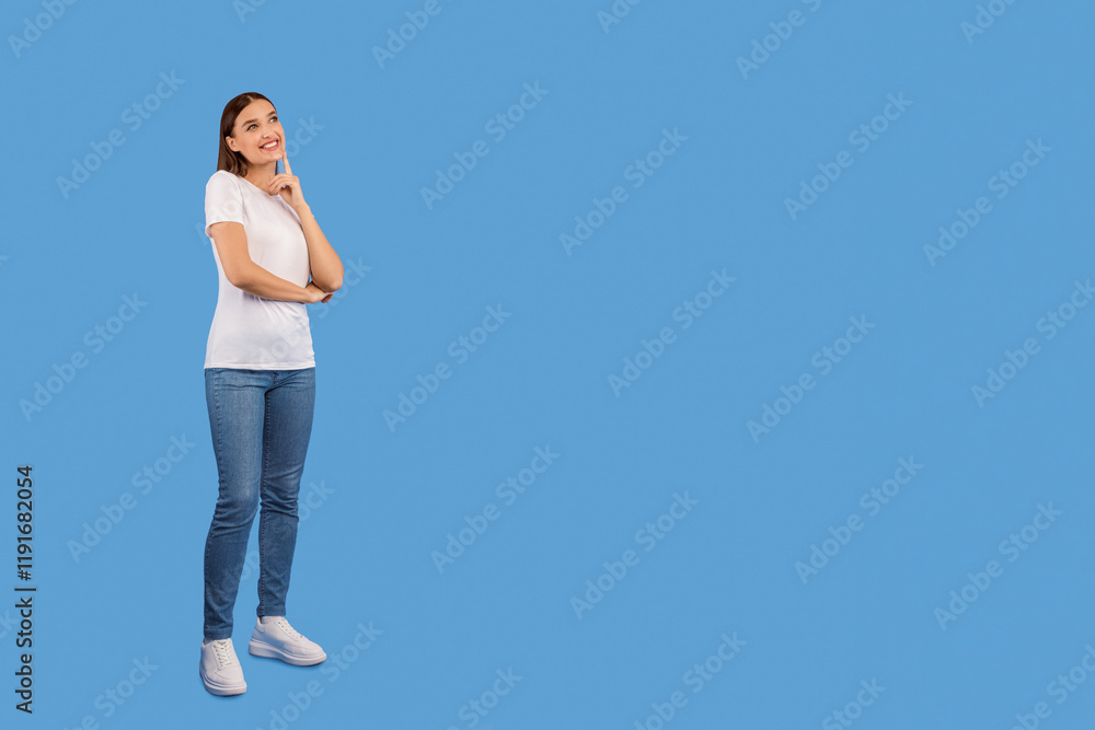 Making Decision. Full length portrait of smiling girl looking up, holding hand on chin, isolated over purple wall, copyspace Making Decision. Full length portrait of smiling girl looking up, holding hand on chin, isolated over purple wall, copyspace