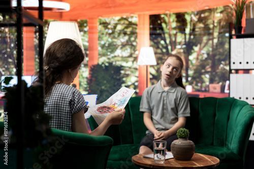 Billede på lærred Young girl getting angry at psychologist when reviewing disturbing drawings, showing signs of murder deviant behavior