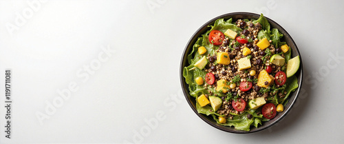 Fresh vibrant salad bowl with mixed greens, cherry tomatoes, diced mango, black beans, and corn showcasing a wholesome, healthy meal presented on a clean, minimalistic background photo