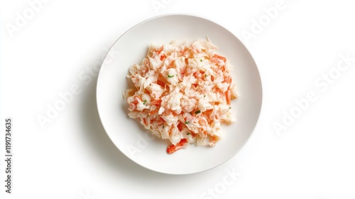 Crab salad served on a white plate, isolated on white background.