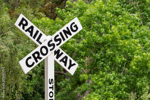 Wallpaper Mural Railway crossing sign for trains with a green natural forest behind it.  Torontodigital.ca