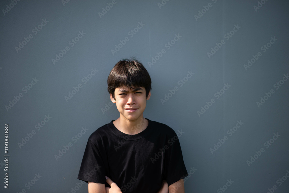 Fototapeta premium Teenage Boy's Expressions Collage: A captivating grid showcases a young Asian boy's diverse facial expressions, capturing a range of emotions from joy to contemplation.