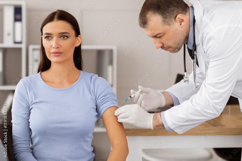 Fototapeta premium Covid-19 Vaccination. Female Patient Getting Vaccinated Against Coronavirus Receiving Covid Vaccine Intramuscular Injection During Doctor's Appointment In Hospital. Corona Virus Immunization