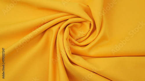 Close-up of golden yellow cotton fabric showing a detailed woven texture, soft natural fibers, and a smooth textile surface perfect for design or background use.