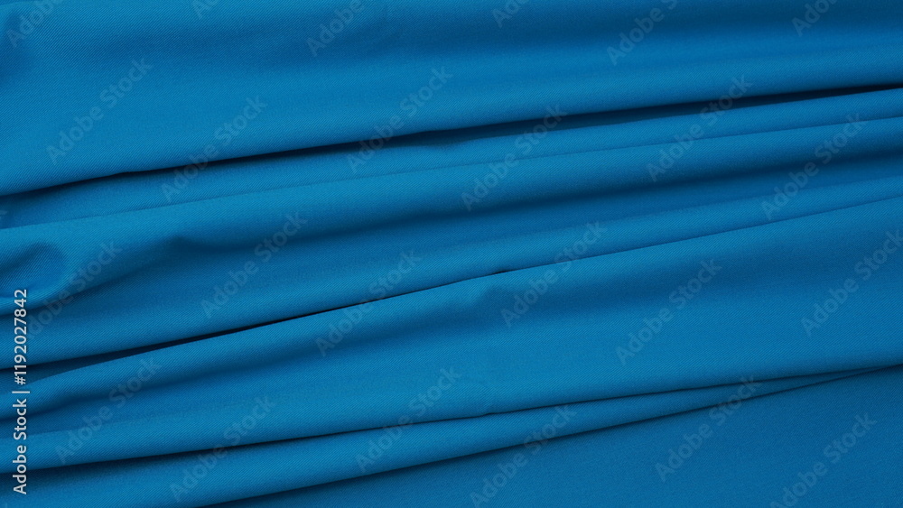 Obraz premium Close-up of blue cotton fabric showing a detailed woven texture, soft natural fibers, and a smooth textile surface perfect for design or background use.
