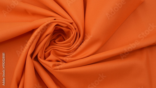 Close-up of orange cotton fabric showing a detailed woven texture, soft natural fibers, and a smooth textile surface perfect for design or background use.