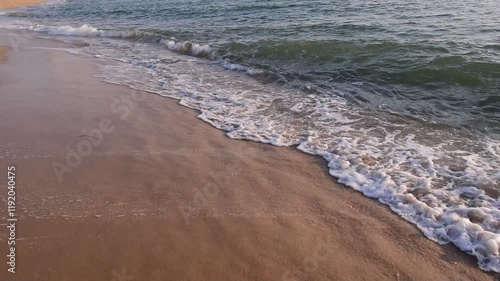 Wallpaper Mural abstract washed-out sea with wave and foam, shoreline in the sunset light, glare and bokeh, sunset on the beach, Footsteps in the sand on the beach Torontodigital.ca