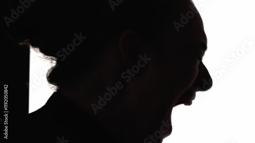 Screaming silhouette. Mental disorder. Nervous breakdown. Emotional crisis. Dark contrast profile of frustrated woman yelling isolated on white free space background.