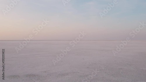 4K Aerial shot of salt flats at rann of Kutch during sunrise. White desert of Kutch in Gujarat, India. Aerial view over the expansive salt marsh of The Great Rann of Kutch. Tranquil Nature landscape. 