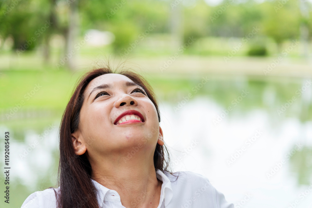 Happy Relax beautiful asian woman smiling face standing in green park outdoors garden. Young women enjoy nature morning Freedom Lifestyle. woman breathing fresh air and relax breath in green park