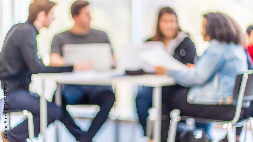 Fototapeta premium Discussion Before Exam – A blurred background of students sharing notes and ideas before an exam. 