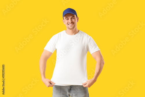 Man in t-shirt and cap on y...