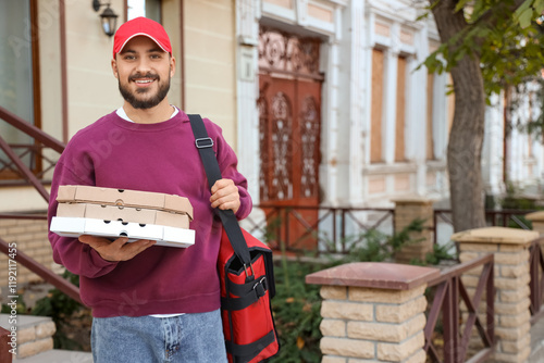 Smiling young delivery man ...