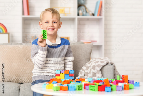 Happy cute little boy playi...