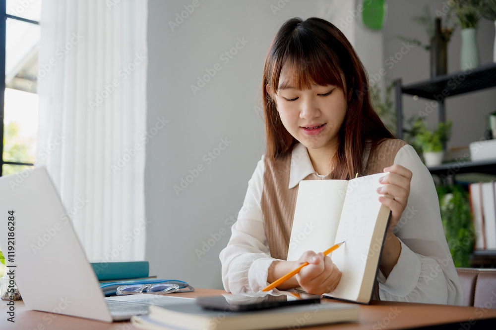 Asian woman using laptop to study student engaged in online learning at college Asian woman using laptop to study student engaged in online learning at college