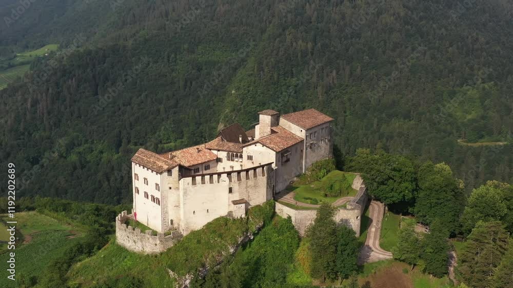 Slow flight point of interest Castle of Stenico. Panoramic view of Stenico Castle in the Valli Giudicarie, Trentino, with lush green surroundings. Slow flight point of interest Castle of Stenico. Panoramic view of Stenico Castle in the Valli Giudicarie, Trentino, with lush green surroundings.