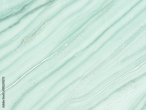 Light green marble texture with wavy, flowing lines and subtle color variations, creating a natural and elegant pattern. Ideal for backgrounds, design projects, or decorative elements
