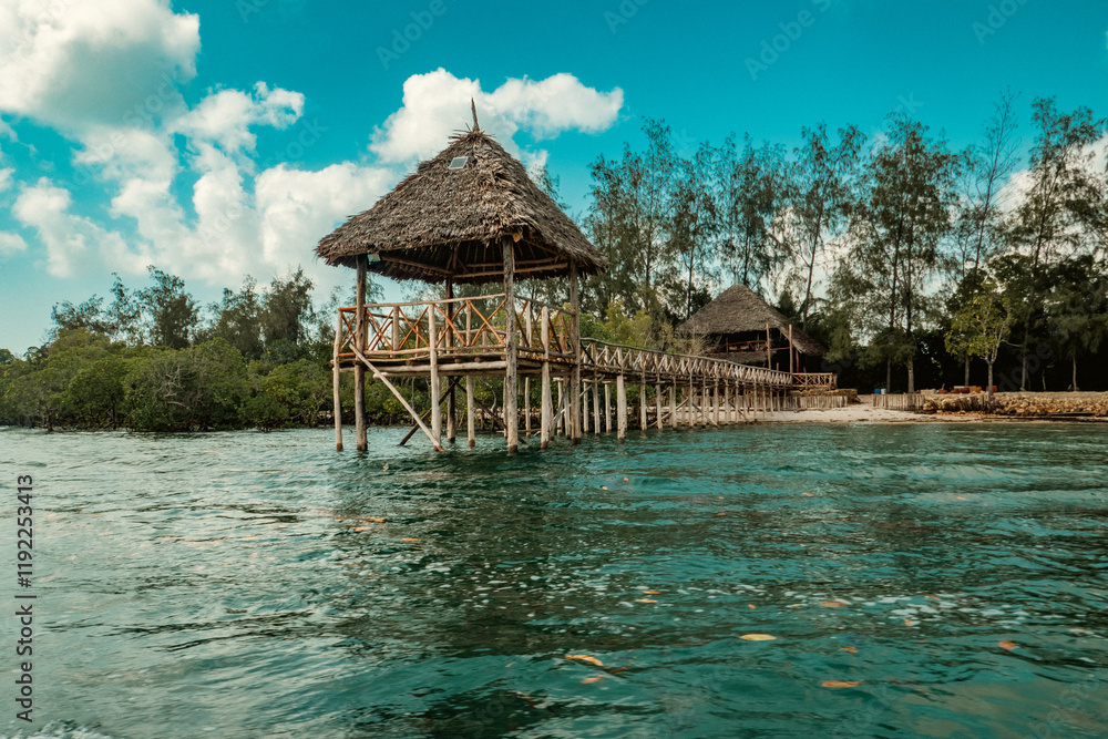 A wooden walkway leading to the the beach at Kinazini Island in Diani, Kenya A wooden walkway leading to the the beach at Kinazini Island in Diani, Kenya