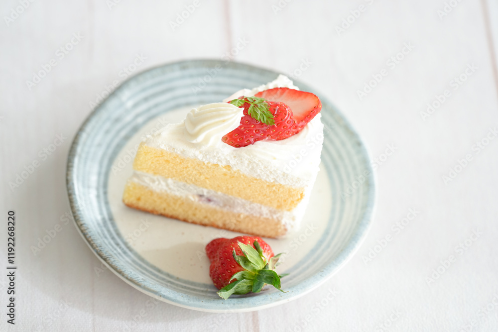 Japanese shortcake with strawberries on top is placed on a white wooden floor Japanese shortcake with strawberries on top is placed on a white wooden floor