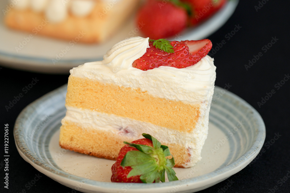 Japanese shortcake with strawberries on top is placed on a black cloth Japanese shortcake with strawberries on top is placed on a black cloth