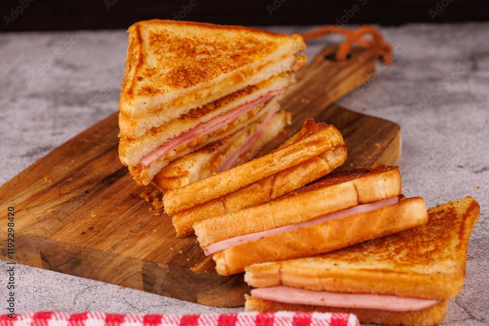 Colorful Ham and Cheese Sandwiches in a Vertical Stack on a Black Table Colorful Ham and Cheese Sandwiches in a Vertical Stack on a Black Table