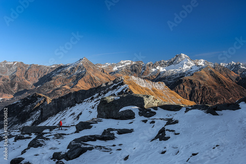 Hikers in the Central Alps with beautiful panorama above Pizzo Groppera and Pizzo Stella, Valchiavenna, Italy photo