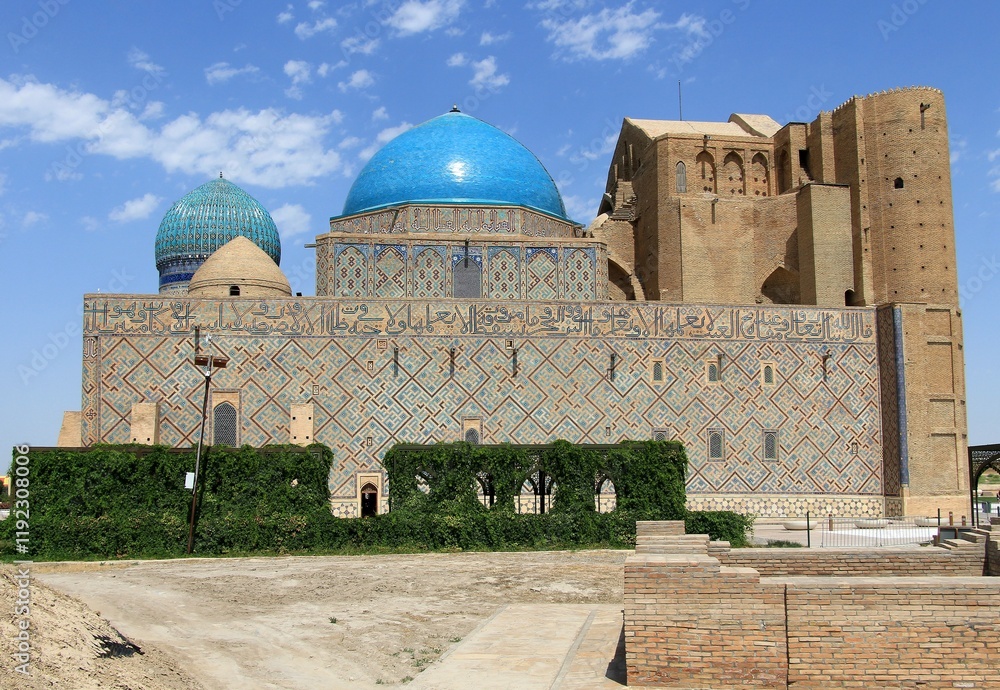 Fototapeta premium Ahmet Yesevi Tomb was built by Timur in 1389. The entrance gate and garden of the social complex. Arabic verses are written on the bottom of the dome.