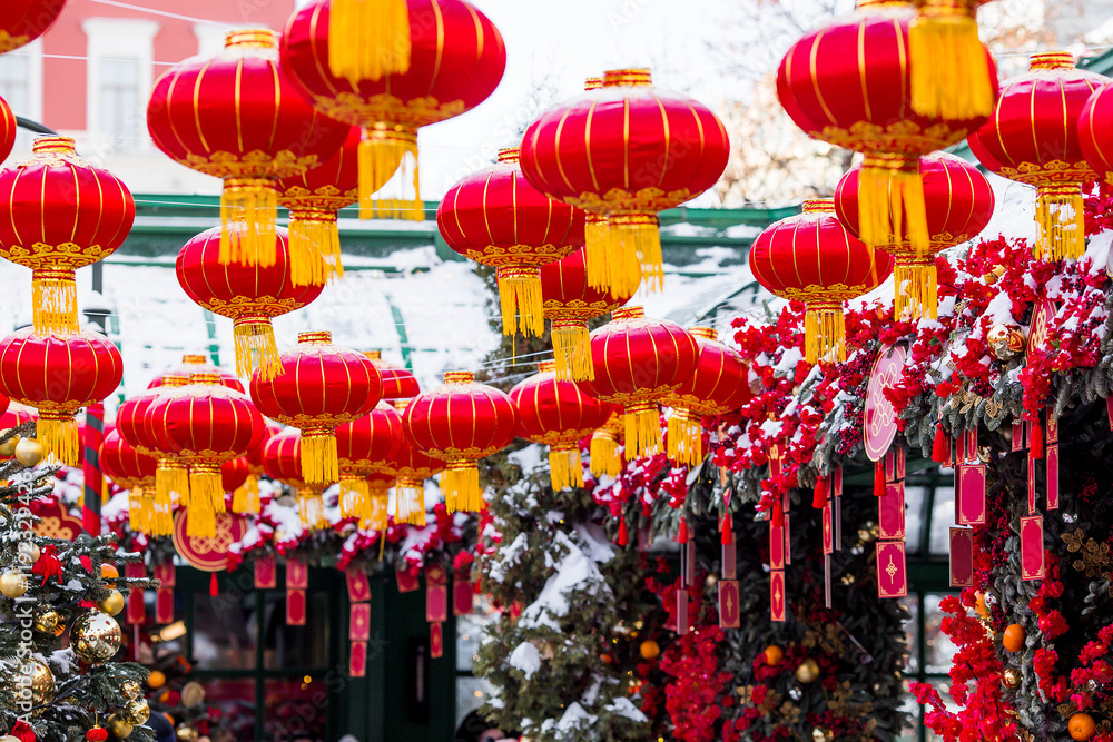 Fototapeta premium Chinese red Christmas lanterns on Tverskaya Street in Moscow. Close-up. The first ever meeting of the Chinese New Year 2024 in Moscow.