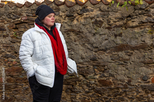 A plus-size woman strolling through the streets of a small European town.