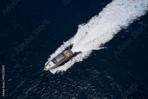 Luxury big yacht gray color with man and woman view from above fast movements in open sea. Expensive yacht gray color on background dark blue sea, fast movement on dark water.