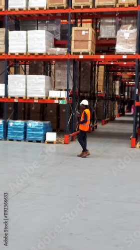 Wallpaper Mural Logistics operator walking through warehouse using a handheld device Torontodigital.ca