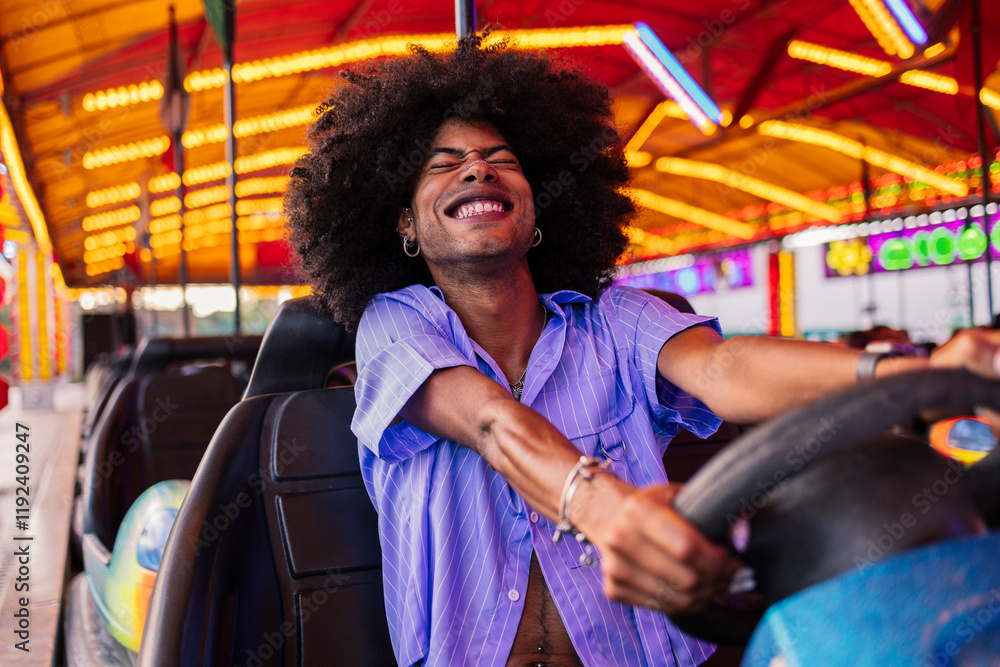 © Westend61 - Playful young Afro man enjoying in bumper car at amusement park © Westend61 - Playful young Afro man enjoying in bumper car at amusement park