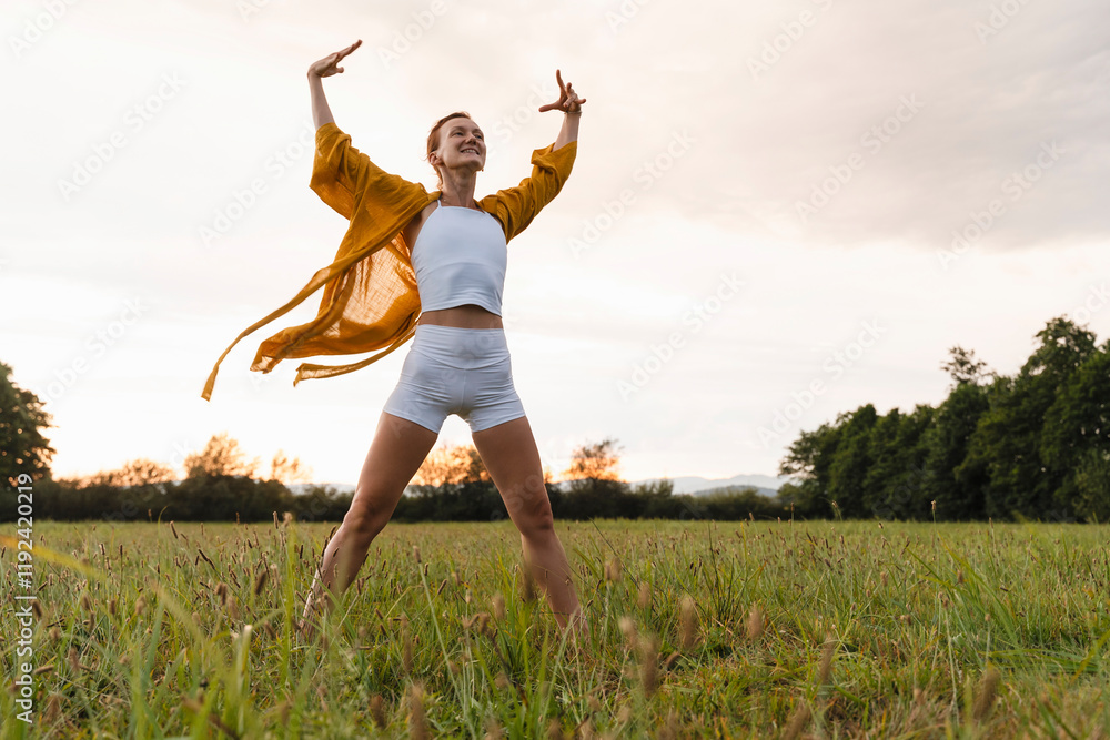 Cheerful woman standing on grass in meadow Cheerful woman standing on grass in meadow