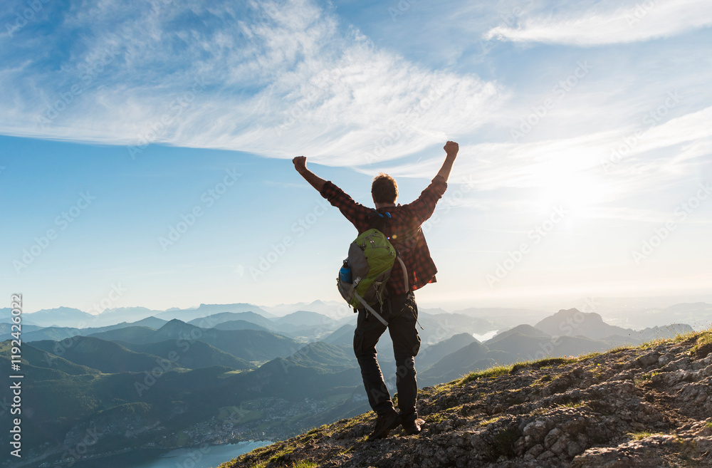 Hiker man celebrating on top of mountain Hiker man celebrating on top of mountain
