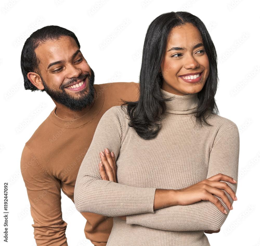 Obraz premium Young Latino couple in studio smiling confident with crossed arms.