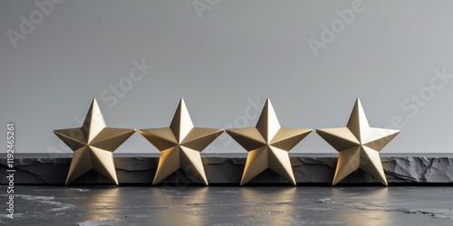 Four golden stars standing on slate stone surface representing positive feedback for customer satisfaction photo