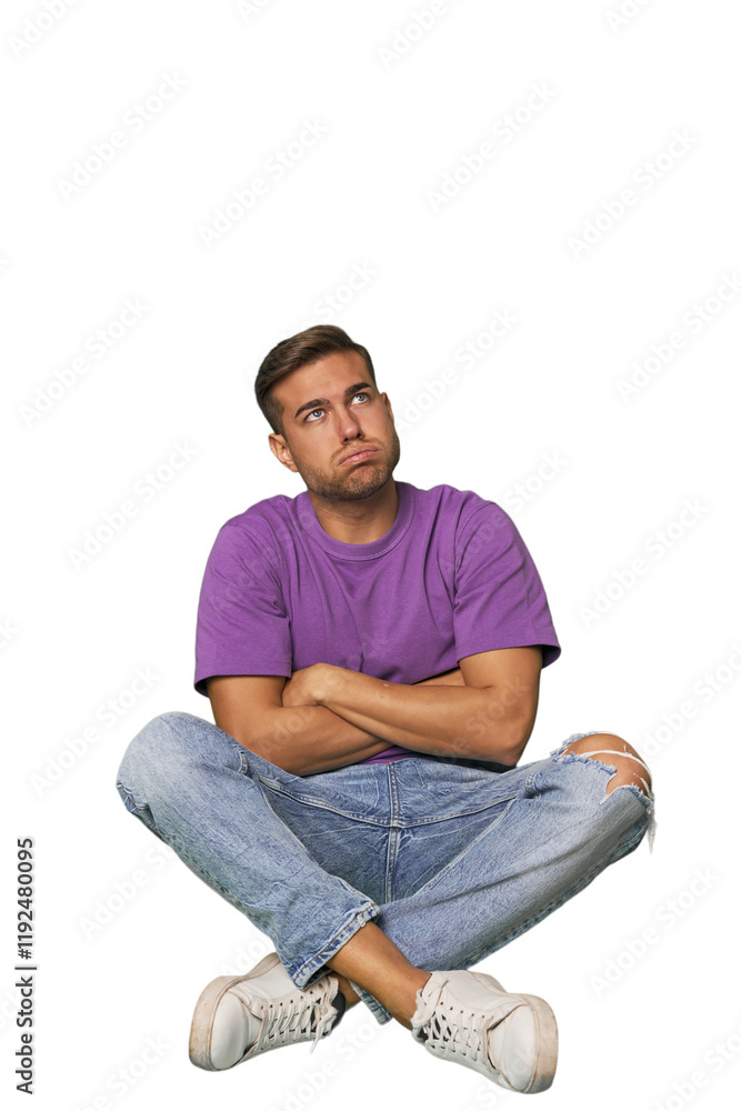 Casual man sitting on floor tired of a repetitive task. Casual man sitting on floor tired of a repetitive task.