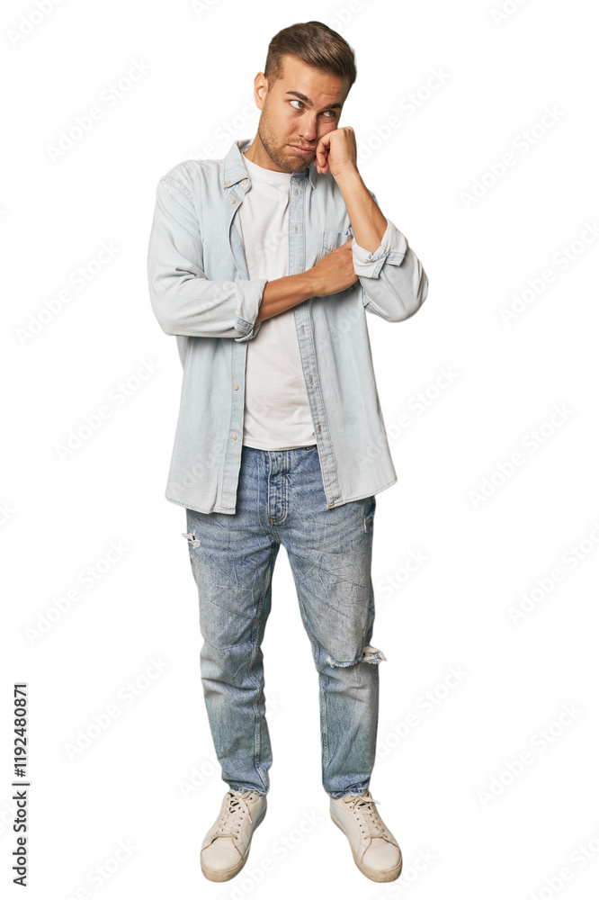 Full body portrait of a man in studio who feels sad and pensive, looking at copy space. Full body portrait of a man in studio who feels sad and pensive, looking at copy space.