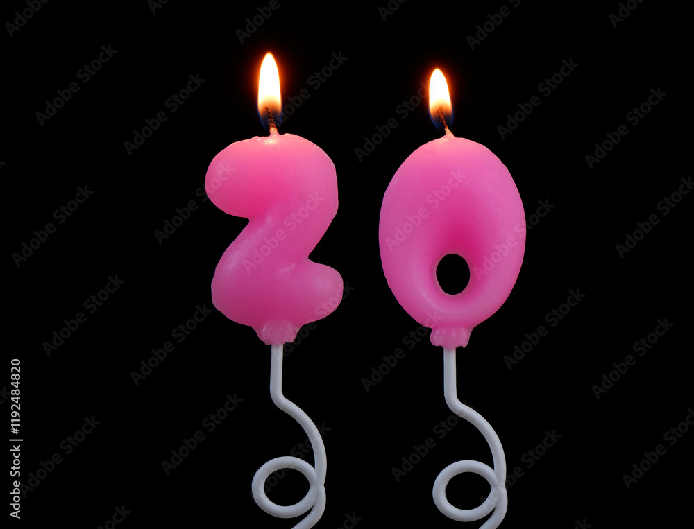 Burning pink air balloon shaped birthday candles isolated on black background. Number 20.	