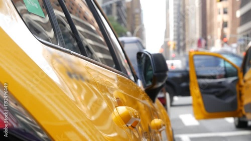 New York City. Yellow taxi car on Manhattan street. Taxi cab on Midtown Lexington avenue. Medallion taxicab rear view on Lex ave waiting for people or passengers on road. Urban scene in United States.