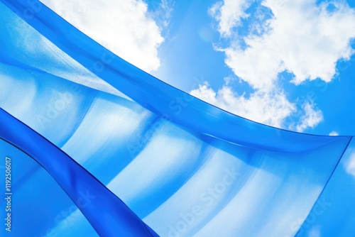 A piece of blue fabric blows in the wind beneath a cloudy sky, great for representing freedom and movement