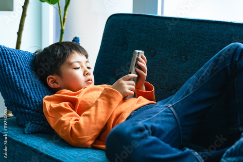 smartphone, smart phone, child, boy, game, internet, video, online, mobile, play, sleep, lie down, web, search, male, man, kid, cell phone, mobile phone, rest, lifestyle, japanese, asian, watch, indoo