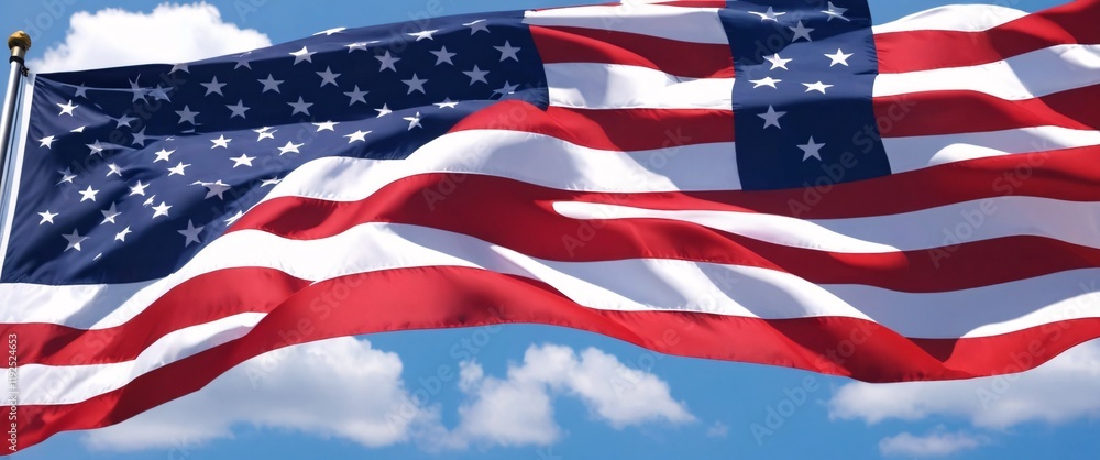 Fototapeta premium American Flag Waving: A vibrant American flag billows majestically in the wind, its red, white, and blue stripes and stars symbolizing freedom, unity, and patriotism.