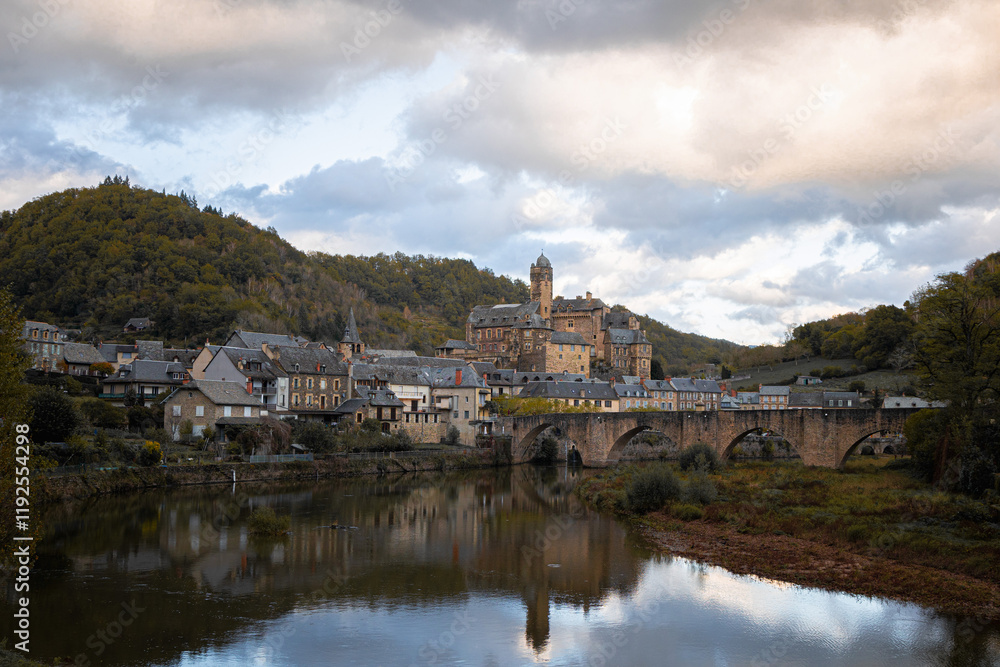 Fototapeta premium Panoramic View of Estaing Village and Castle with Reflections on the Lot River, Occitania, France