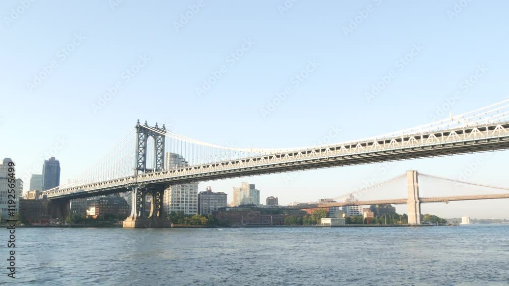 New York City Manhattan Bridge to Dumbo, Brooklyn Bridge. Waterfront skyline cityscape from Pier 35, USA. East river iconic view, morning sunset by water. Riverfront architecture. NYC landmark. New York City Manhattan Bridge to Dumbo, Brooklyn Bridge. Waterfront skyline cityscape from Pier 35, USA. East river iconic view, morning sunset by water. Riverfront architecture. NYC landmark.