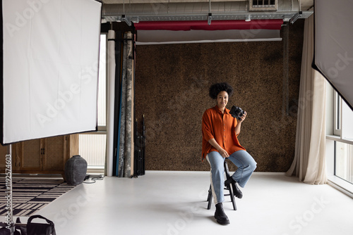 Portrait of an African American female photographer sitting in her studio photo