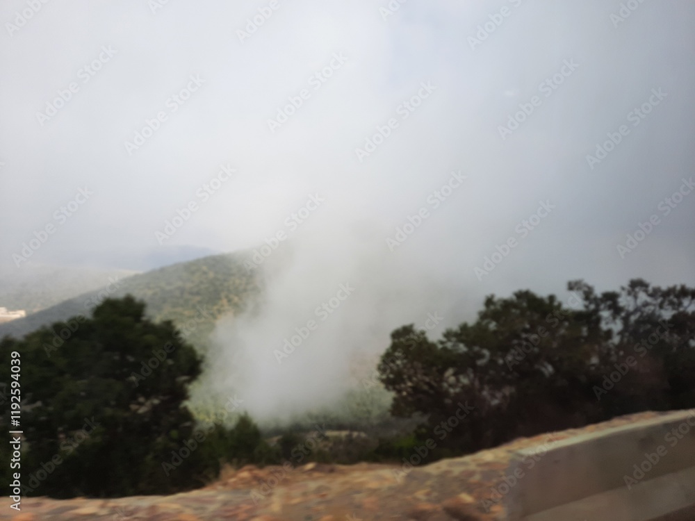 Fototapeta premium Beautiful view of the misty mountains and the surrounding area from Al Soudah View Point, Strawberry Farm in Abha.